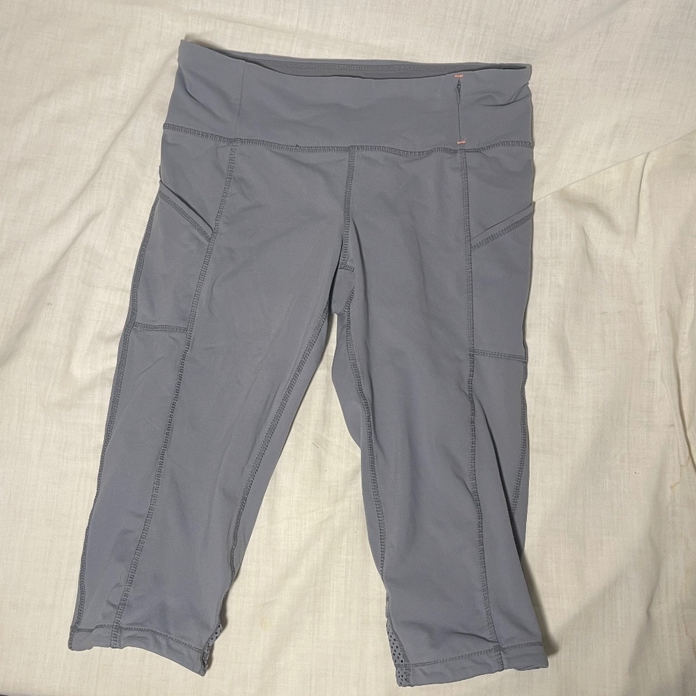 Athleta Capri Leggings. Zip pocket Mesh at leg bottoms. Athletic wear Sz Medium